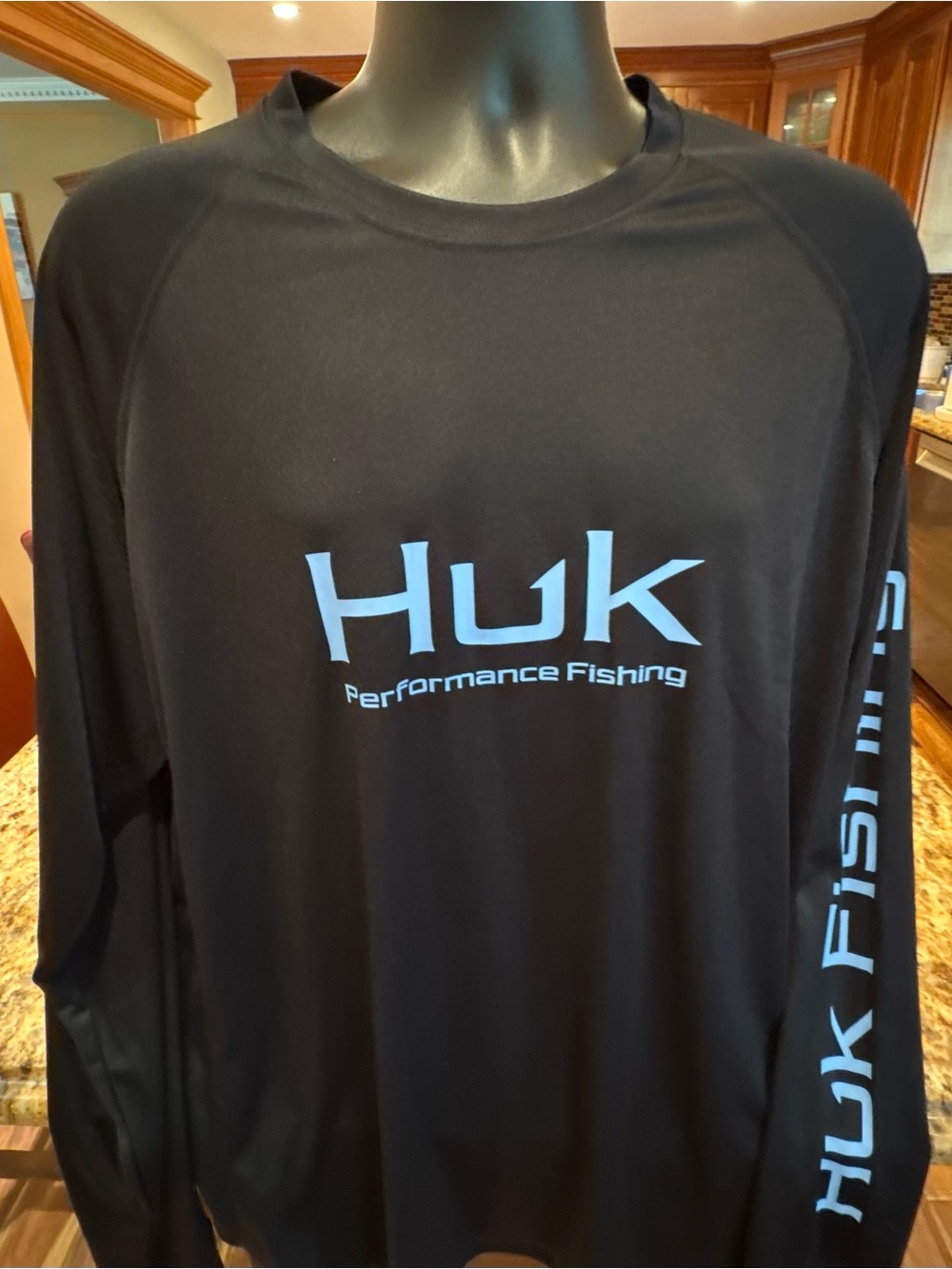 Huk men’s long sleeve performance Fishing Shirt. Sharp Black with blue logos.